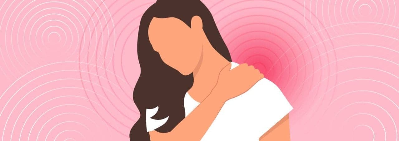 A woman holding her shoulder in pain